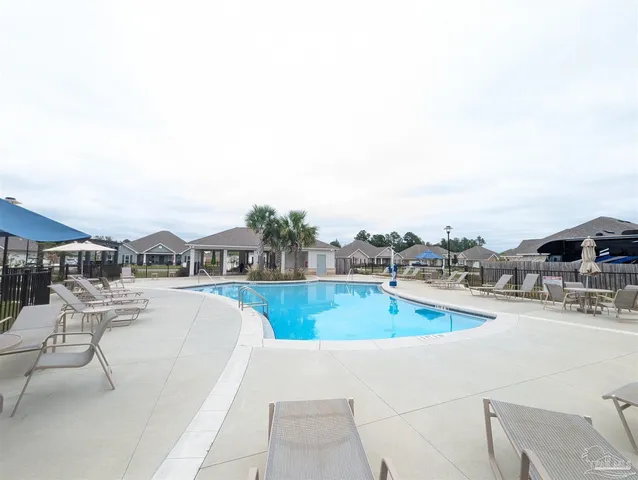 a view of a swimming pool and lounge chair
