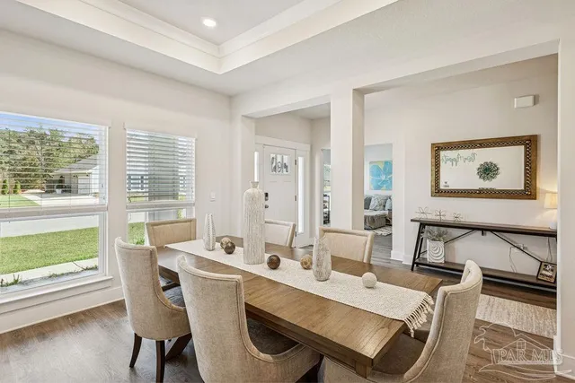 a view of a dining room with furniture window and wooden floor