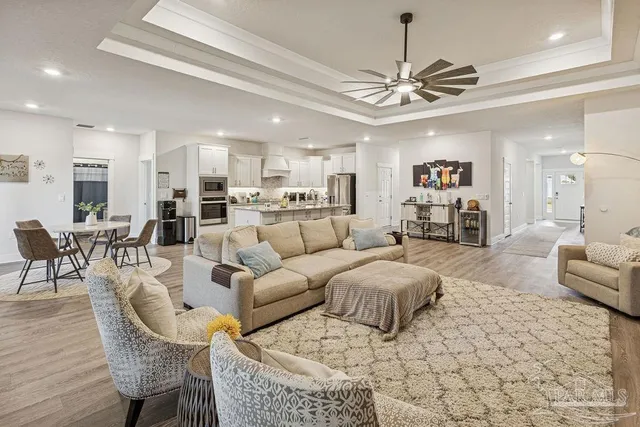 a living room with furniture and a chandelier