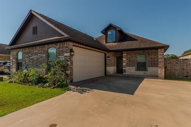 6385 Highpoint Avenue Beaumont, TX 77713 - Photo 1 of 20 a front view of a house with a yard and garage