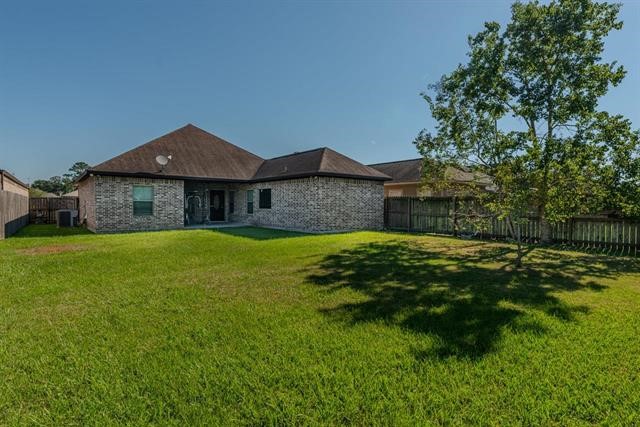 6385 Highpoint Avenue Beaumont, TX 77713 - Photo 17 of 20 a front view of a house with garden