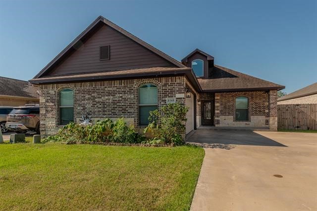 6385 Highpoint Avenue Beaumont, TX 77713 - Photo 2 of 20 a front view of a house with garden