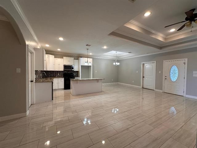 6385 Highpoint Avenue Beaumont, TX 77713 - Photo 3 of 20 a view of kitchen with kitchen island a sink stainless steel appliances and cabinets