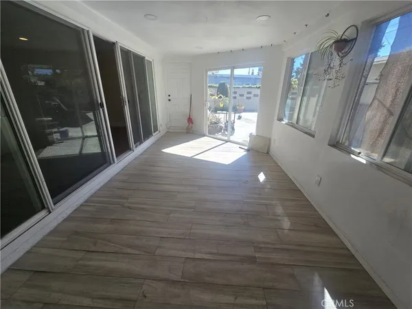 a hallway with sliding door and wooden floor
