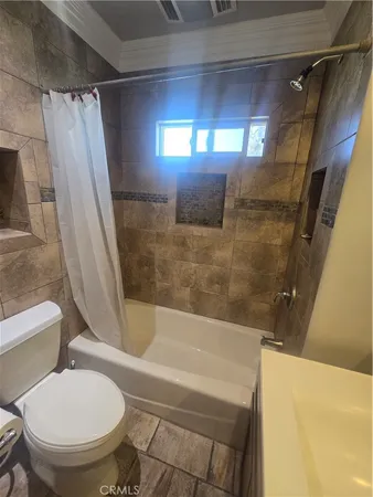 a bathroom with a toilet and a tub