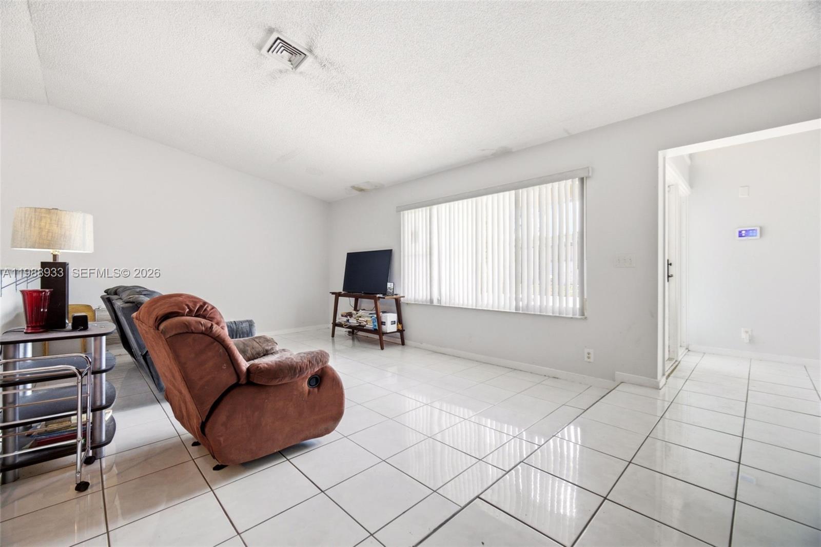841 Southwest 55th Avenue Margate, FL 33068 - Photo 5 of 26 a living room with furniture and a window