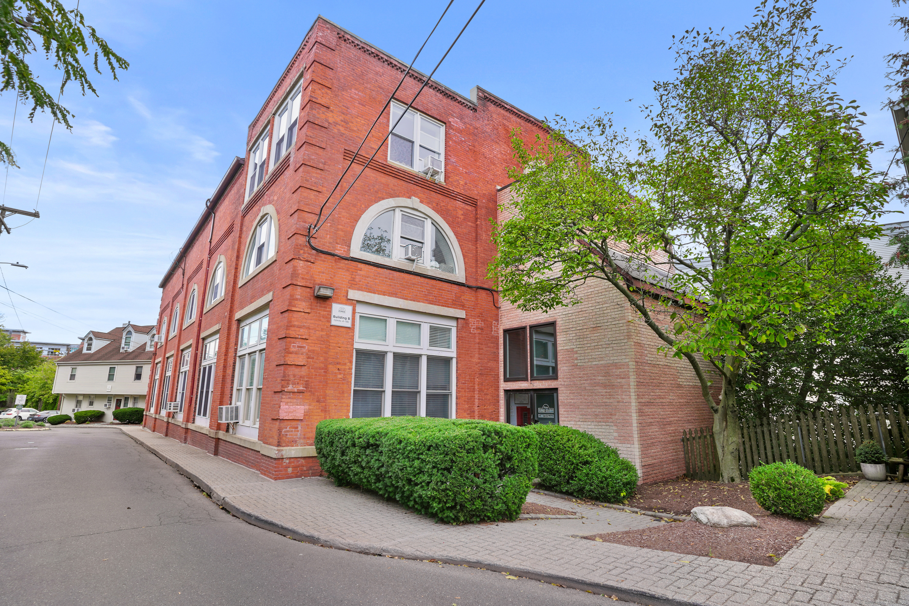 a view of a brick building next to a yard