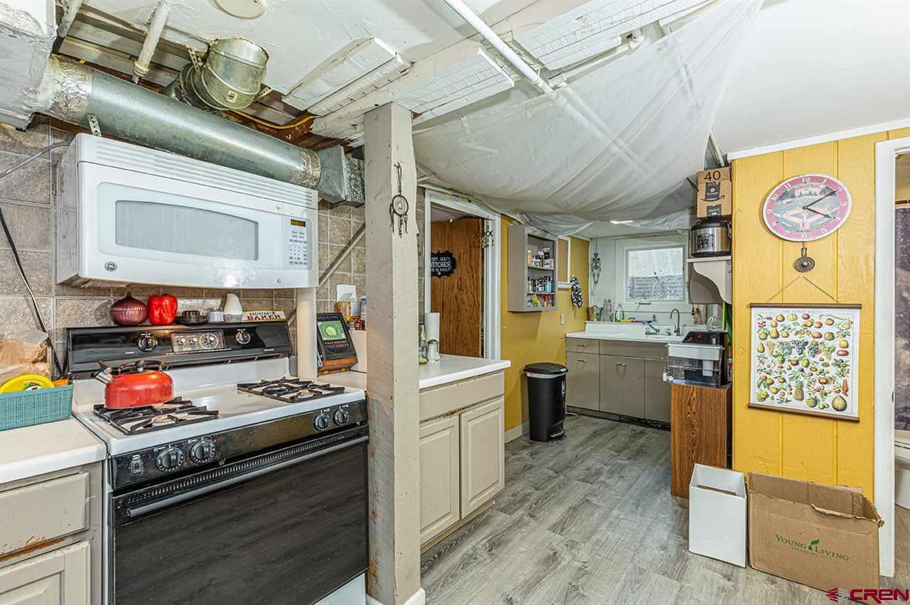 3575 Main Avenue Durango, CO 81301 - Photo 14 of 32 a kitchen with stainless steel appliances granite countertop a stove and a refrigerator