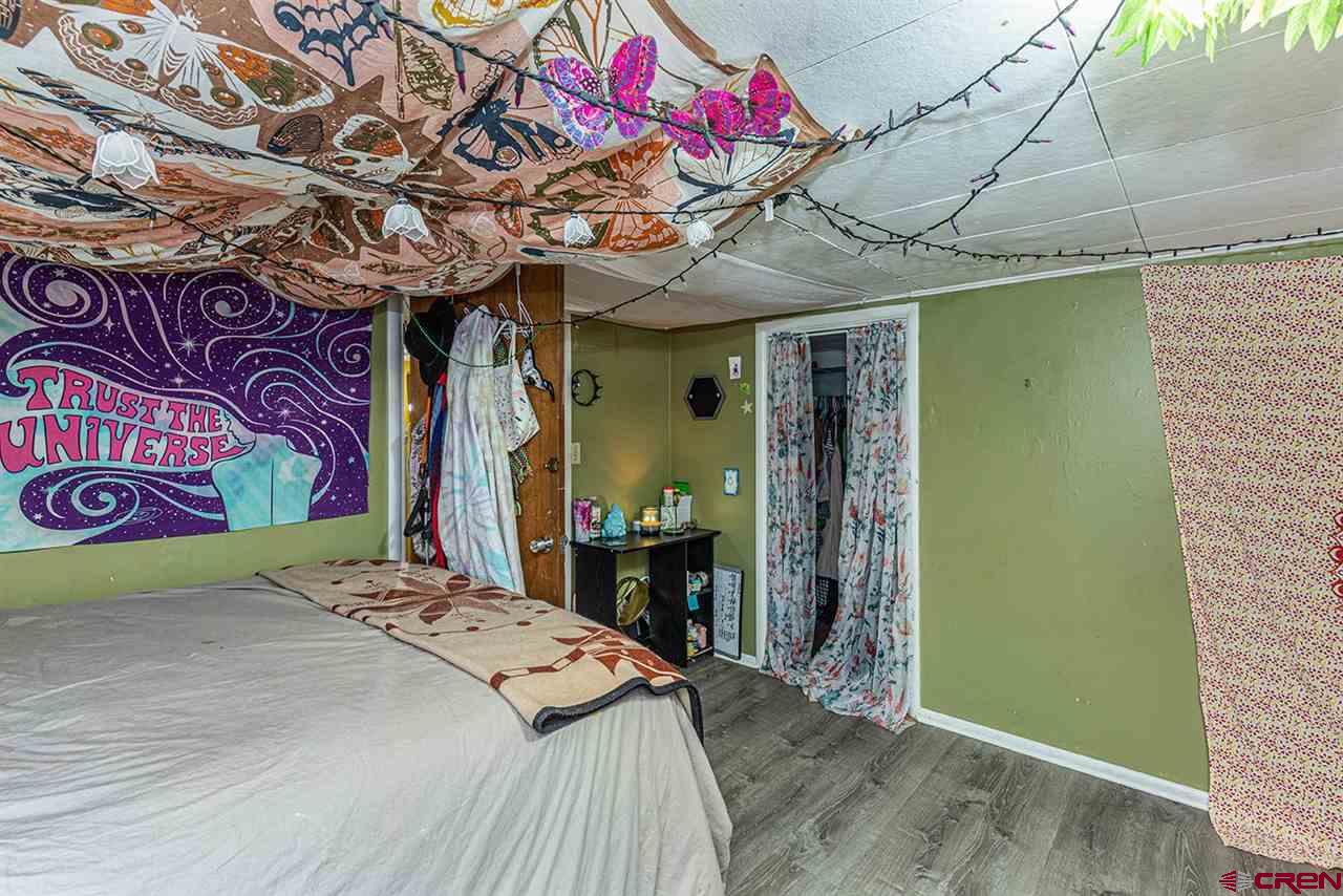 3575 Main Avenue Durango, CO 81301 - Photo 17 of 32 a bedroom with a bed and a chandelier