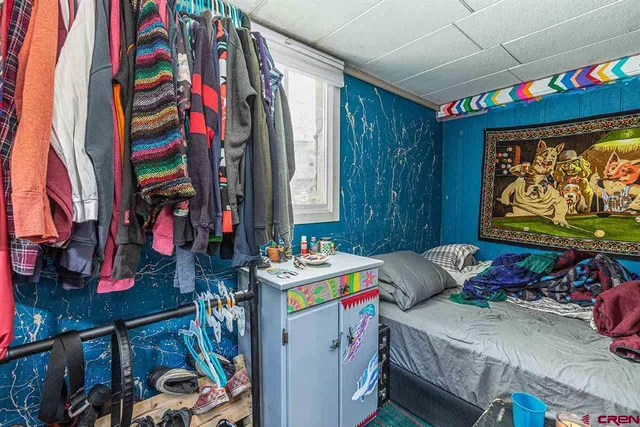 a living room with lots of furniture and a book shelf