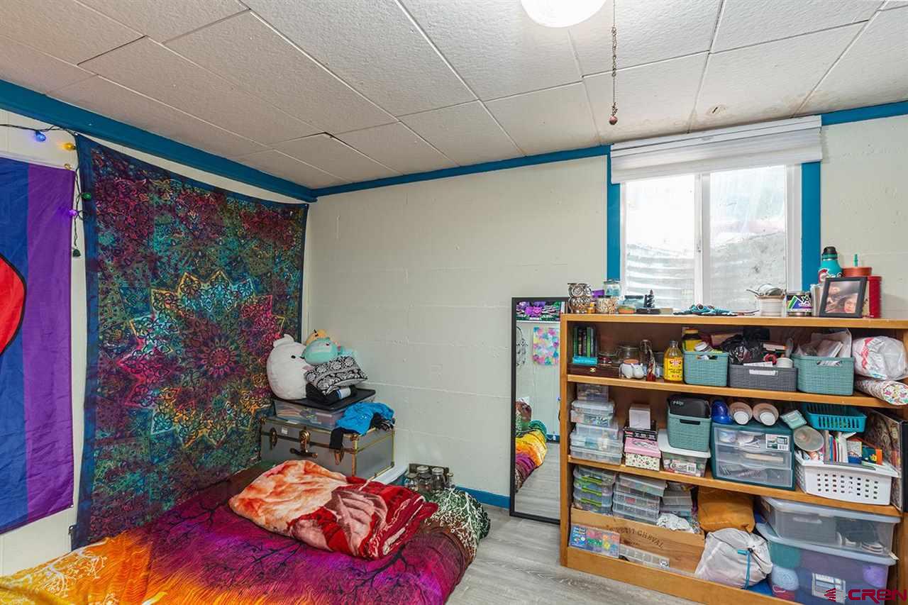 3575 Main Avenue Durango, CO 81301 - Photo 19 of 32 a living room with lots of furniture and a book shelf