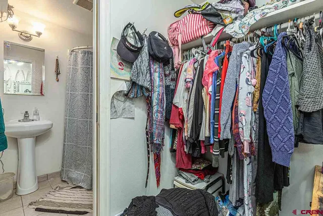 a bedroom with a bed and a potted plant
