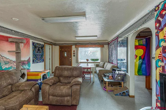 a living room with furniture and a floor to ceiling window