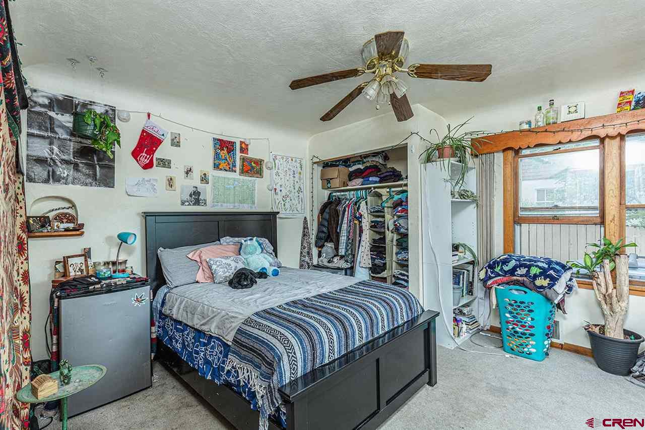 3575 Main Avenue Durango, CO 81301 - Photo 21 of 32 a bedroom with a bed and a potted plant