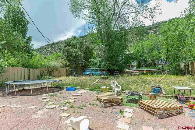 a backyard of a house with table and chairs