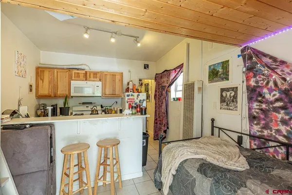 a kitchen with granite countertop a sink a stove and cabinets