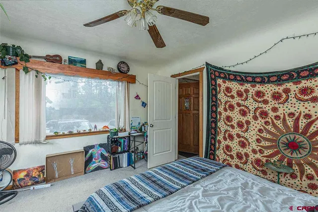 a bedroom with furniture and a large window