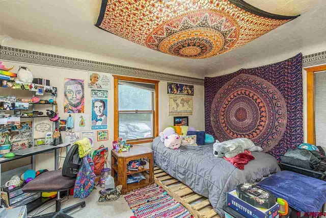 a bed room with furniture and a window