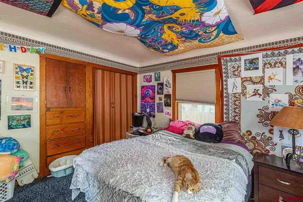 a bed sitting in a bedroom next to a window