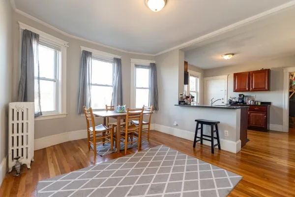 a view of a dining room with furniture window and wooden floor