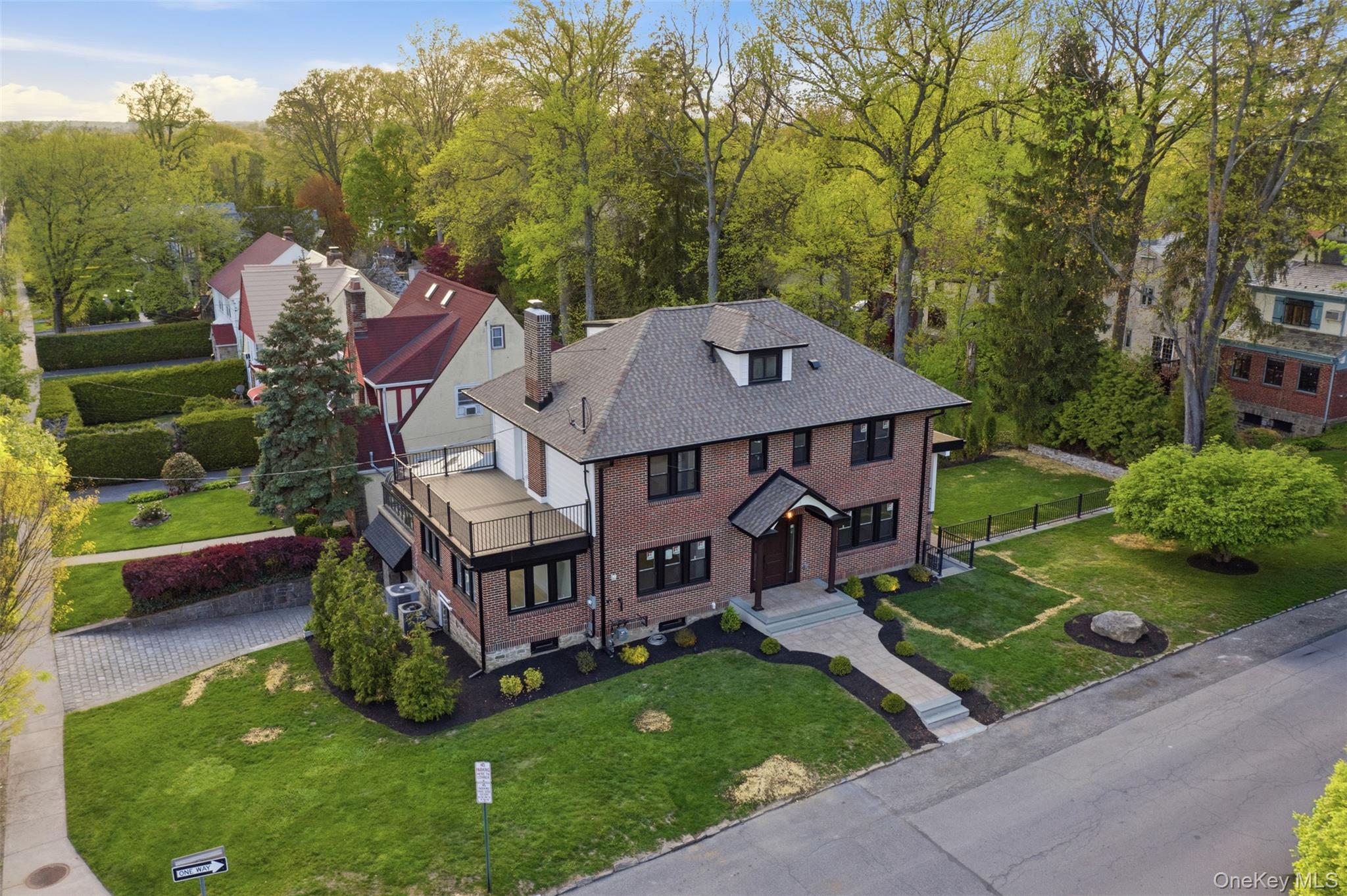 40 Calhoun Avenue New Rochelle, NY 10801 - Photo 41 of 49 Brick facade residence featuring a dark shingle roof and dormer