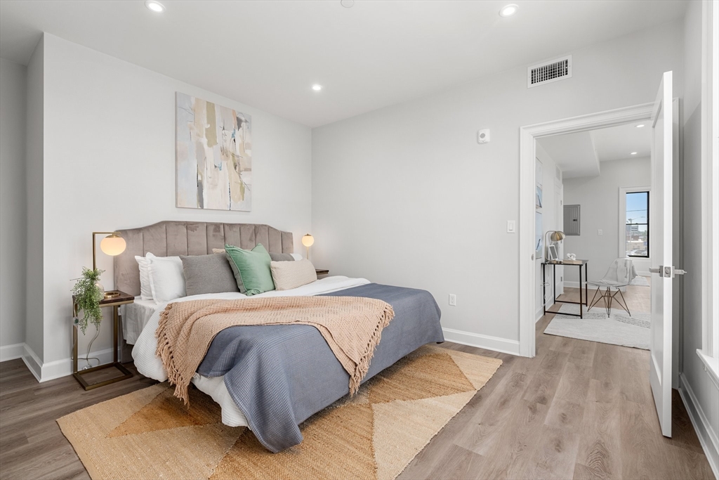 523 2nd Street, Unit 403 Everett, MA 02149 - Photo 6 of 10 a bedroom with a bed and a couch