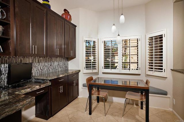 a bathroom with a granite countertop sink a toilet and shower