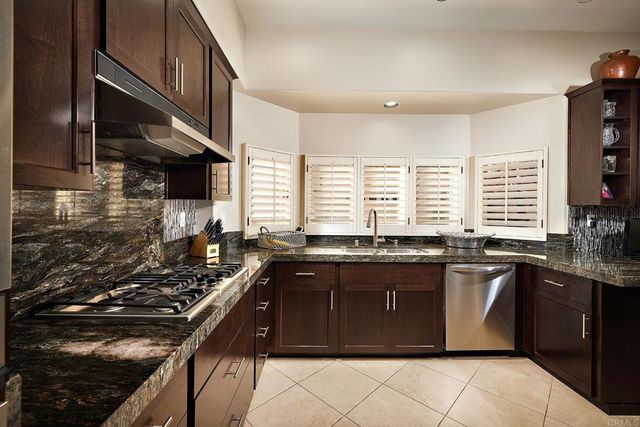 a view of backyard with outdoor seating and plants