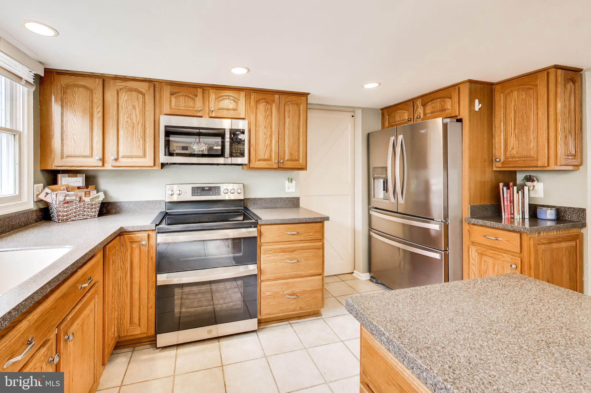 8404 Chillum Court Springfield, VA 22153 - Photo 13 of 56 Modern kitchen with warm wood accents.