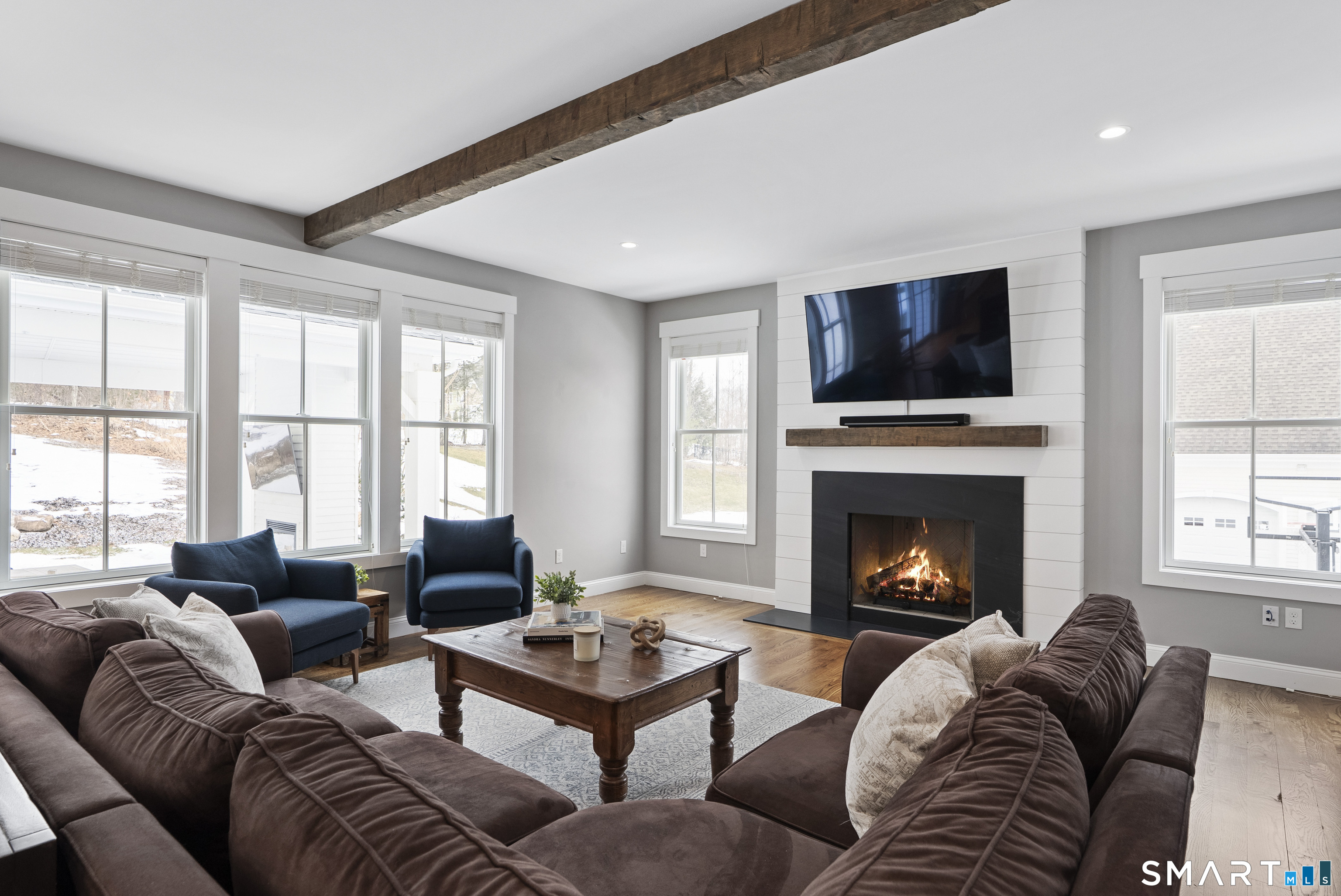 8 Gateshead Way Farmington, CT 06085 - Photo 11 of 39 a living room with furniture a flat screen tv and a fireplace