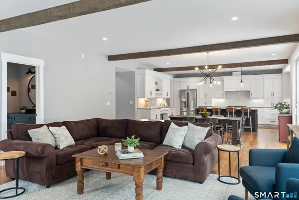 a view of a living room kitchen and a wooden floor