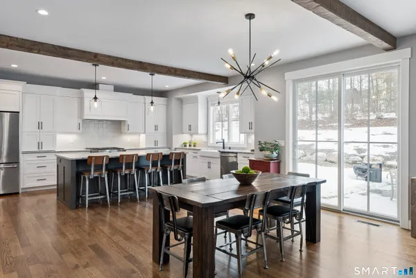 a view of a dining room with furniture window and wooden floor