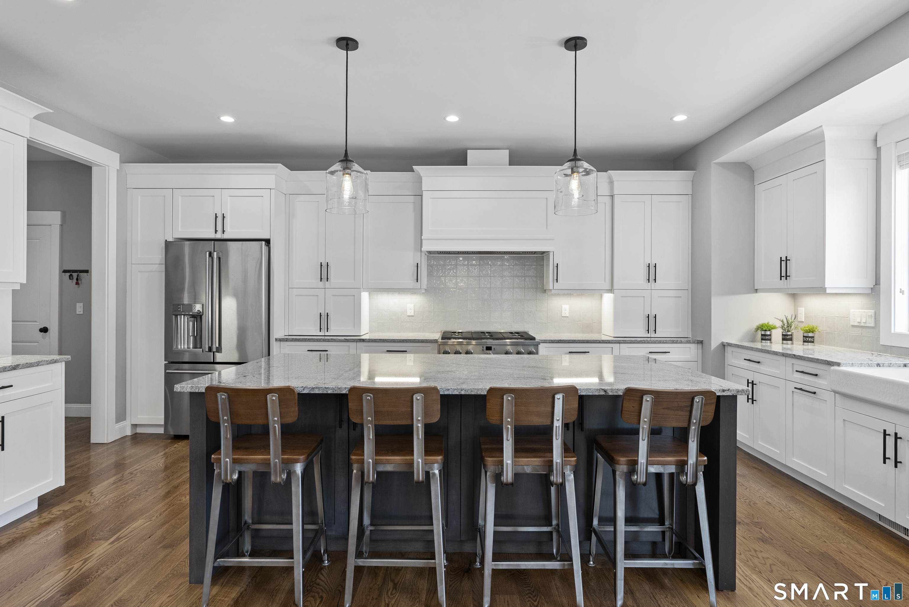 8 Gateshead Way Farmington, CT 06085 - Photo 18 of 39 a kitchen with stainless steel appliances kitchen island granite countertop a dining table chairs sink and cabinets