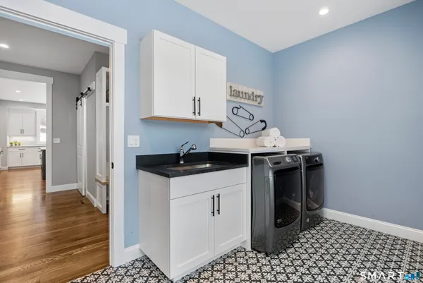 a kitchen with stainless steel appliances a stove a sink and a refrigerator