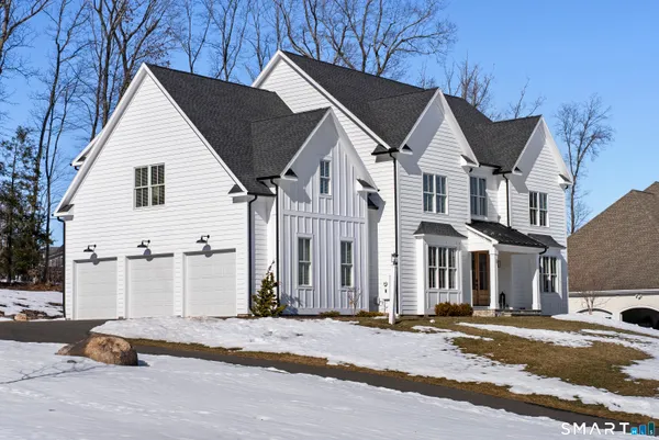 a view of a white house with a street