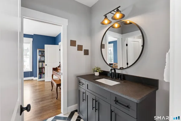 a bathroom with a sink a mirror and a vanity