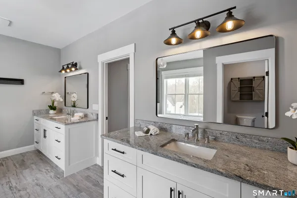 a bathroom with a sink vanity and mirror