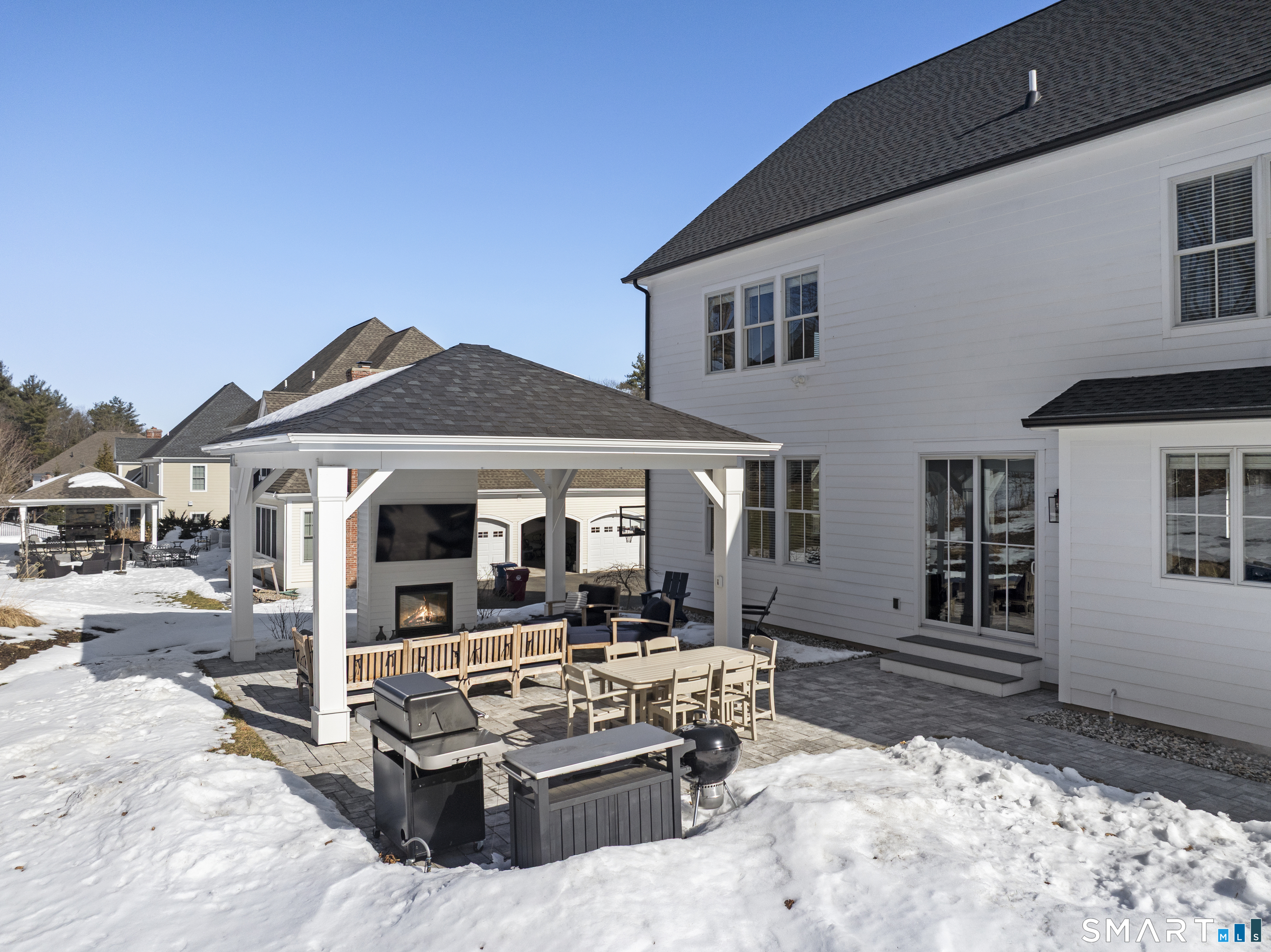 8 Gateshead Way Farmington, CT 06085 - Photo 4 of 39 a view of a white house with large windows next to a road