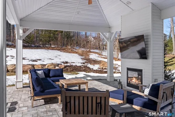 a outdoor living space with patio furniture and a fireplace