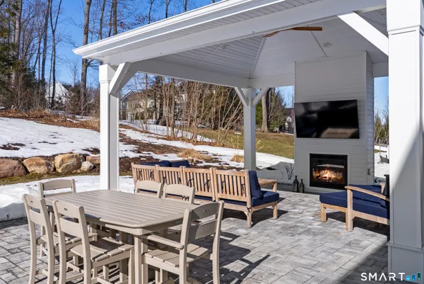 a view of a patio with a table and chairs