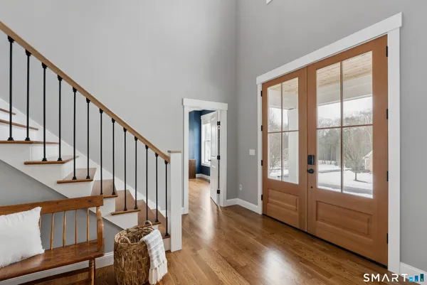 a view of entryway and hall with wooden floor