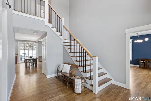 a view of entryway dining room and hall with wooden floor