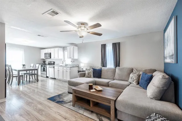 a living room with furniture kitchen view and a dining table