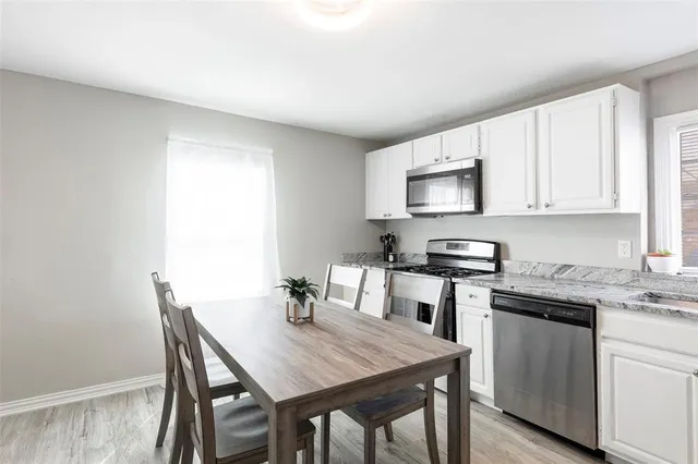 a kitchen with a table and chairs in it