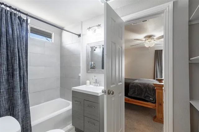 a en suite bathroom with a tub shower and sink