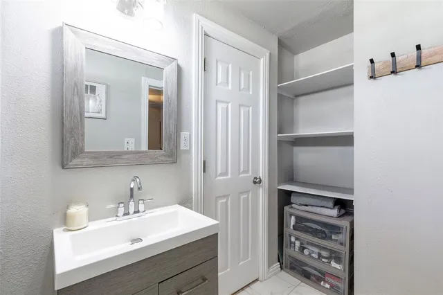 a bathroom with a sink a vanity and a mirror