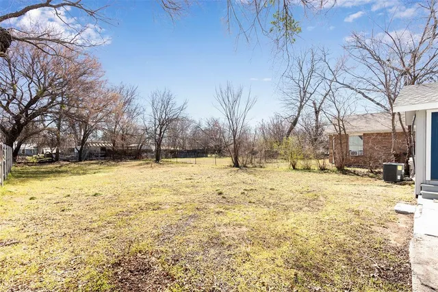 a view of yard covered with snow in front of house