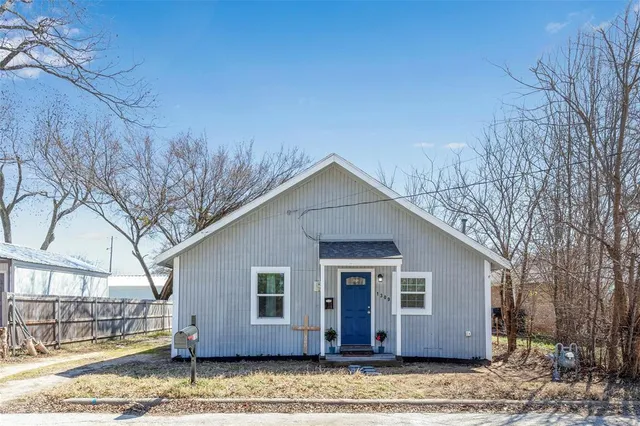 a view of a house with a yard covered in snow