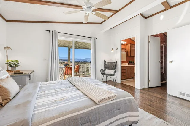 a bedroom with a bed and a mirror