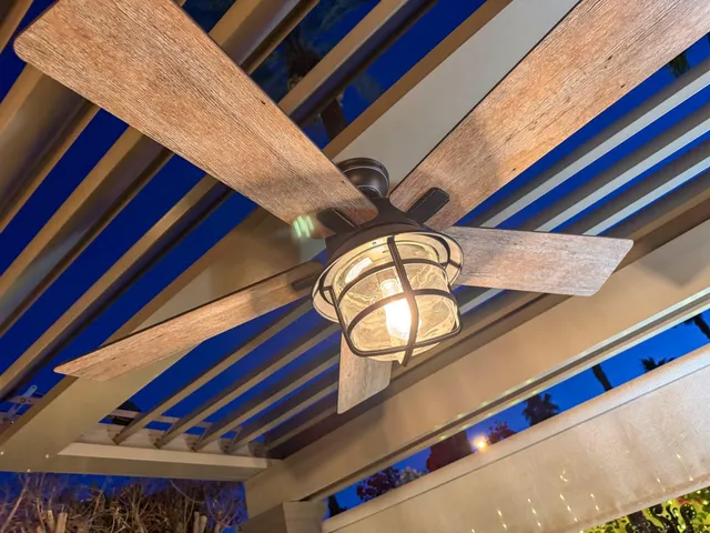 a living room with furniture a lamp and a large window